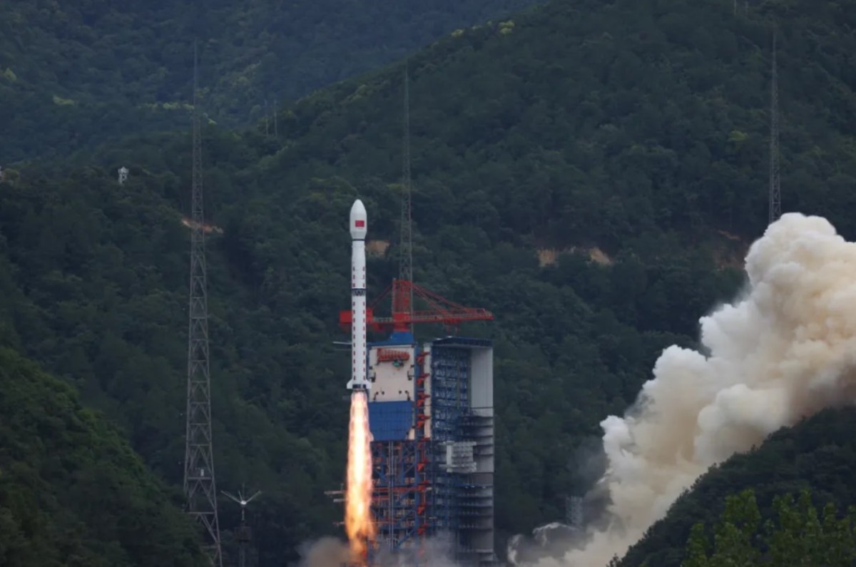 A Long March 4C rocket lifts off from Xichang Satellite Launch Center in a forested mountainous region of southwest China, trailing flames and smoke as it carries the Shiyan-28B (01) satellite into orbit on July 3, 2025.